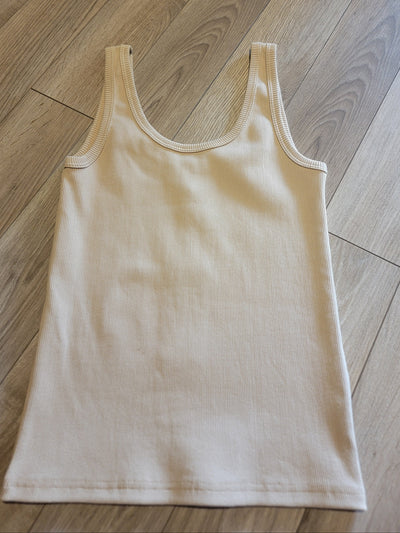 Beige tank top on a wooden floor