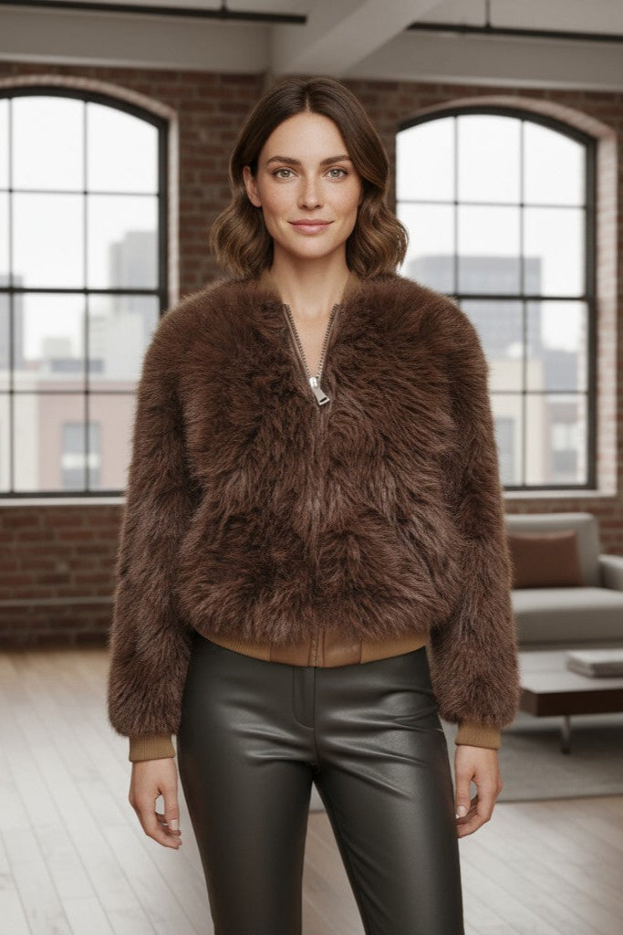 Woman wearing a brown fur jacket in a modern living room.