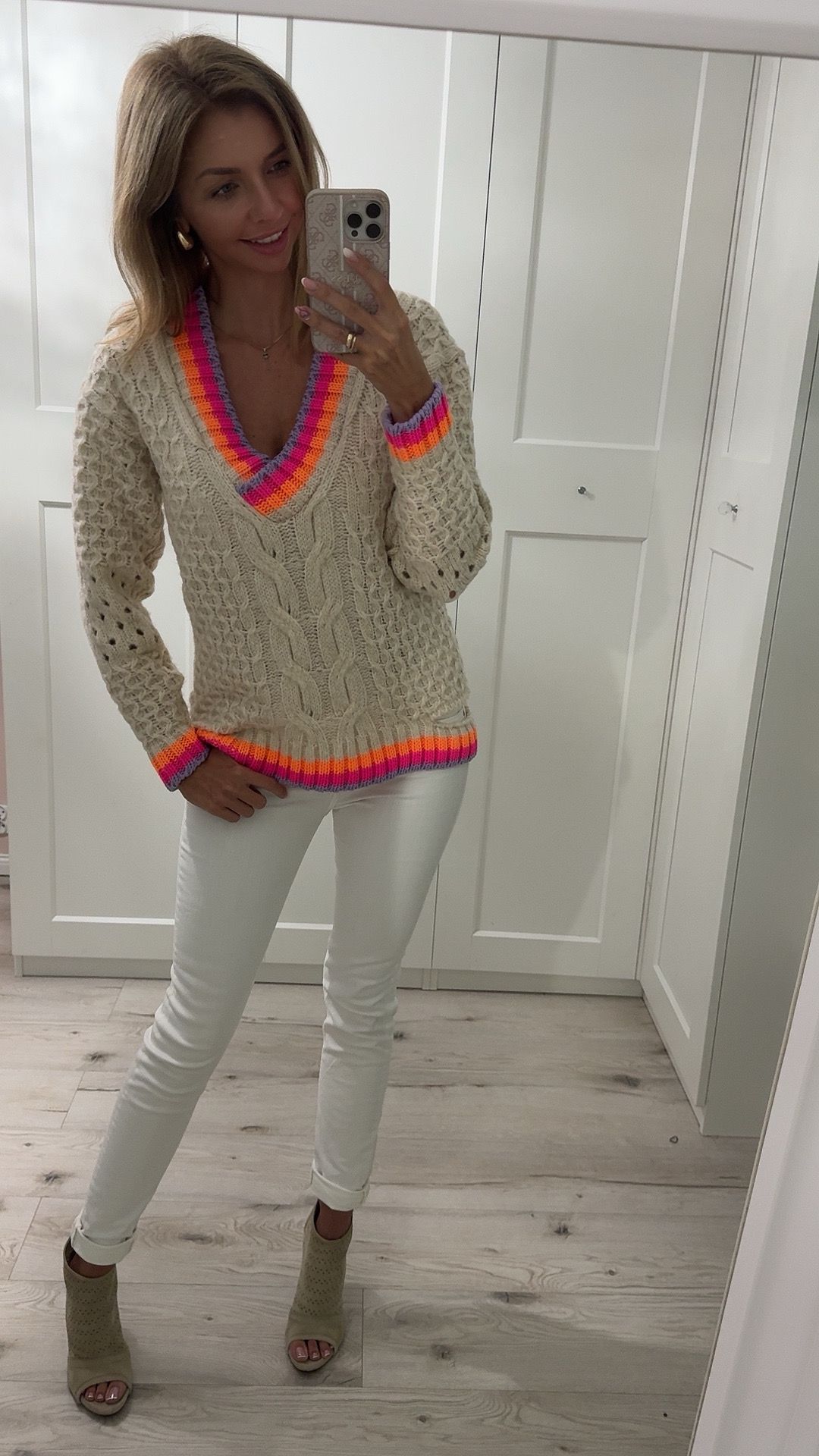 V-neck sweater with colorful details.