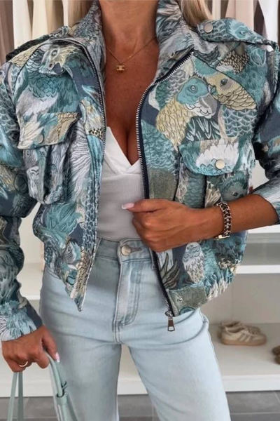 Person wearing a patterned jacket and light blue jeans indoors.