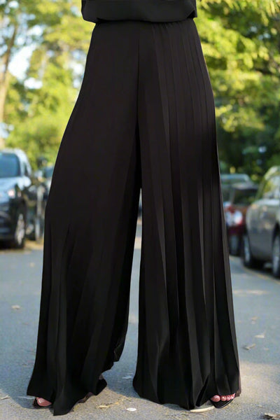 Person wearing a black outfit in a clothing store setting